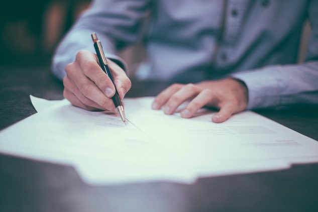 signing an NDA on a desk