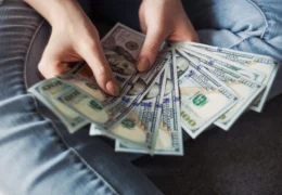 young person fanning one hundred dollar bills after learning what a promissory note is