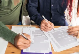 A couple signing legal documents