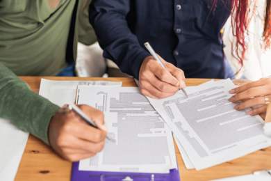 A couple signing legal documents