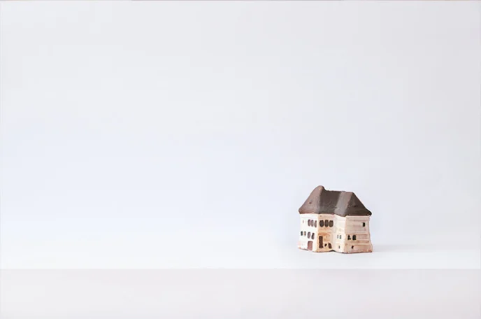 Brown Wooden House Miniature on White Surface