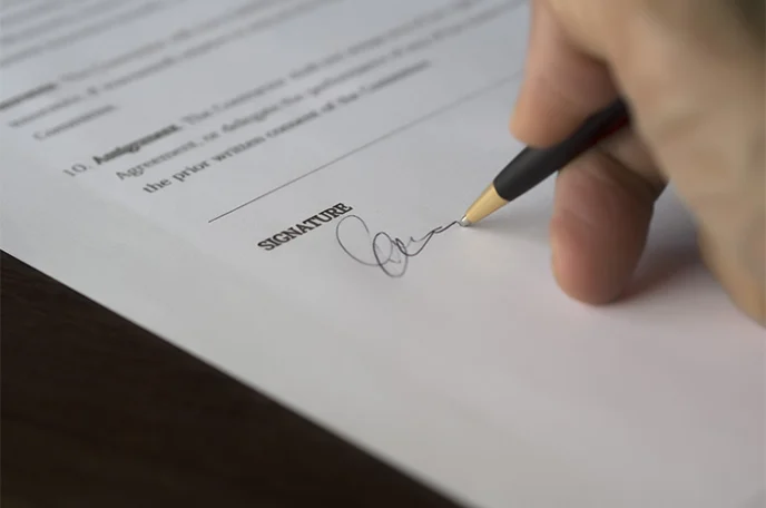 Selective-Focus-Photography-of-Person-Signing-on-Paper-