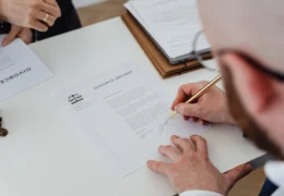 man signing a divorce agreement form