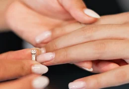 woman-putting-wedding-ring-on-another-woman's-finger